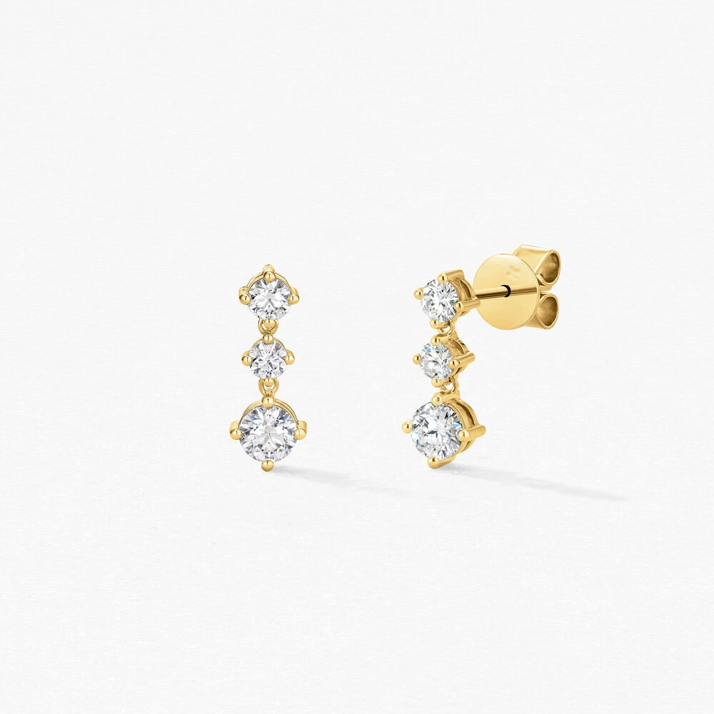 Vue latérale des boucles d’oreilles en or jaune Louvre, montrant le design délicat et la cascade de diamants.